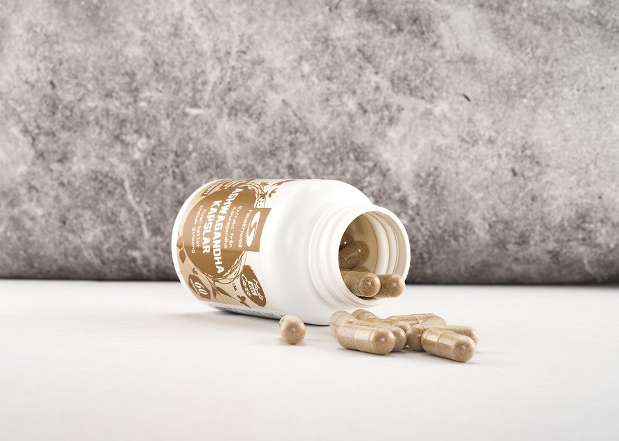 Picture of Ashwagandha Capsules from Healthwell with capsules poured on the table in front of the jar.