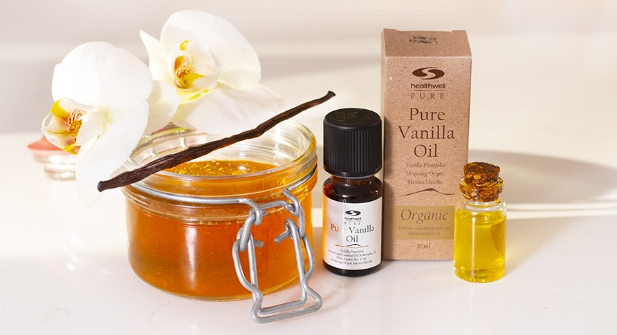 Pure Vanilla Oil ECO next to a jar of honey.