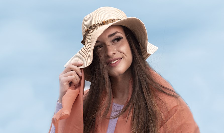 Picture of a girl outdoors with a sun hat.