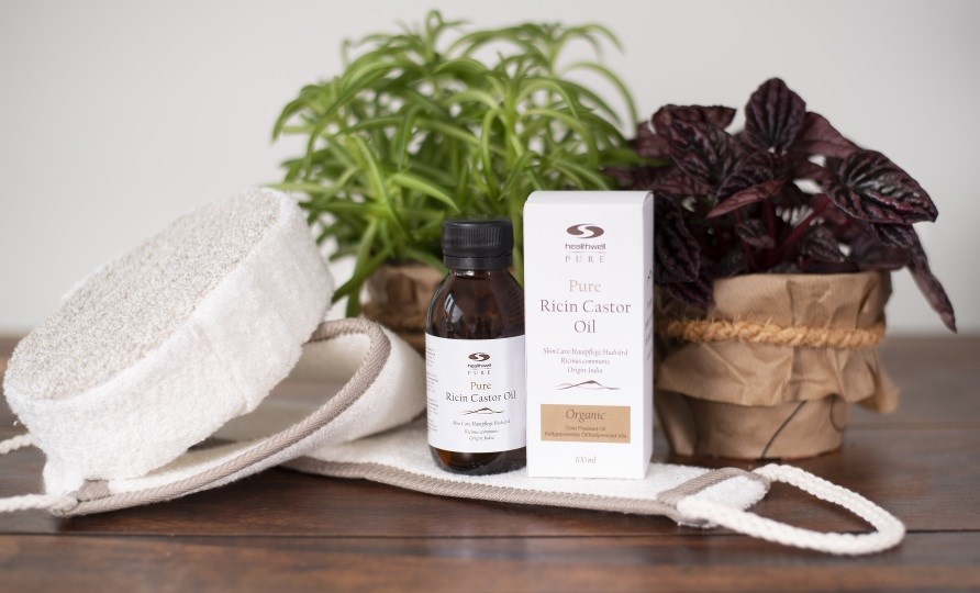 pure castor oil with scrubbing glove