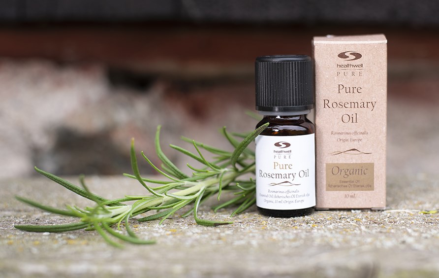 Pure Rosemary oil with a fresh rosemary sprig.